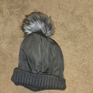Grey Pom-Pom Beanie With A Fleece Lining.